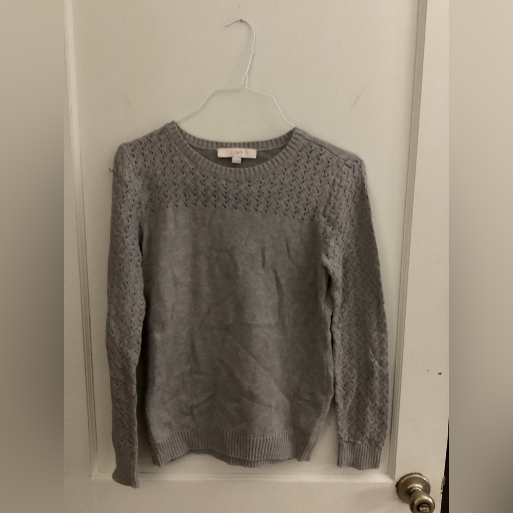 Women’s grey sweater with design around neck collar. Gray in color